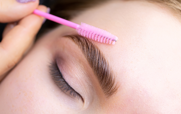 A client’s eyebrow being brushed during her brow lamination treatments