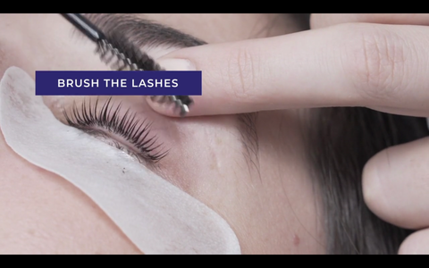 eyelashes being brushed with a mascara wand